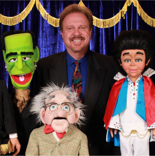 Lee Cornell and 3 of his ventriloquist figures on stage